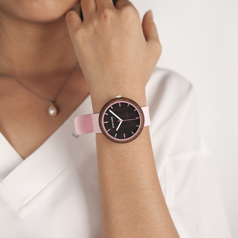 Young female student with new wooden watch